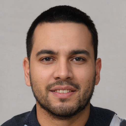 Joyful white young-adult male with short  black hair and brown eyes