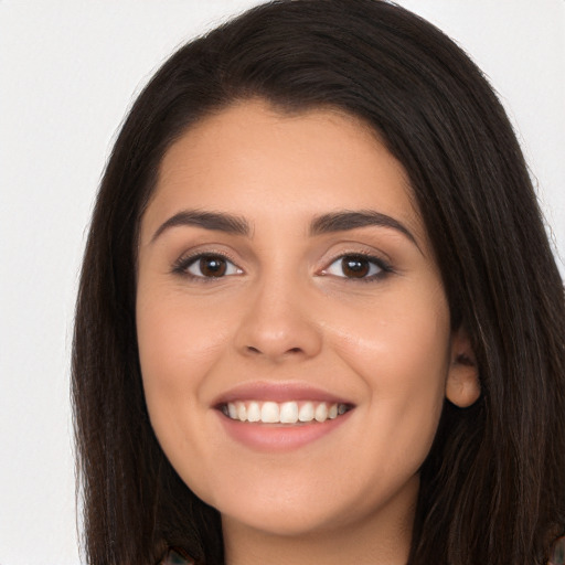 Joyful white young-adult female with long  brown hair and brown eyes