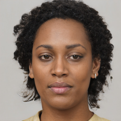 Neutral black young-adult female with medium  brown hair and brown eyes