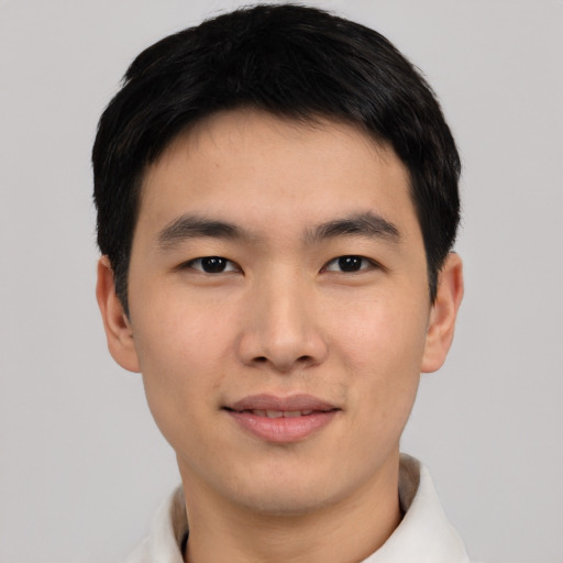 Joyful asian young-adult male with short  black hair and brown eyes