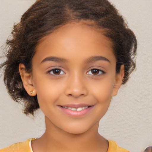 Joyful latino child female with short  brown hair and brown eyes