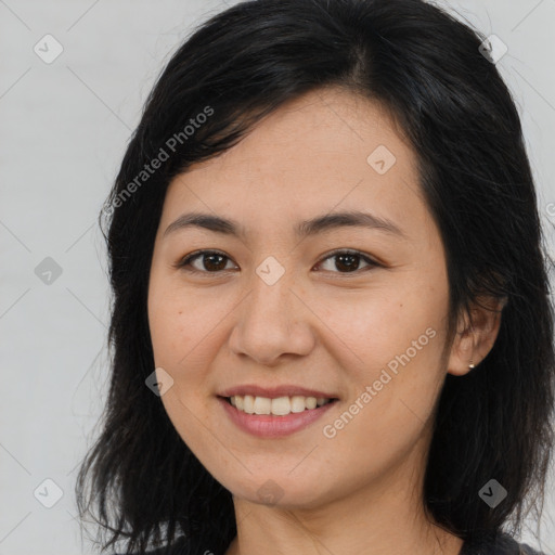 Joyful asian young-adult female with long  brown hair and brown eyes