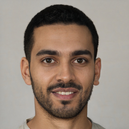 Joyful latino young-adult male with short  black hair and brown eyes