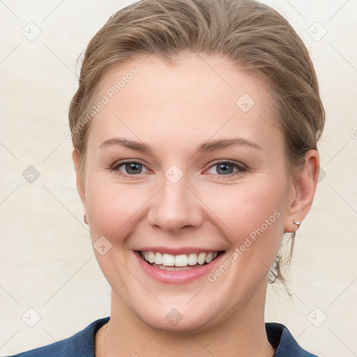 Joyful white young-adult female with medium  brown hair and blue eyes