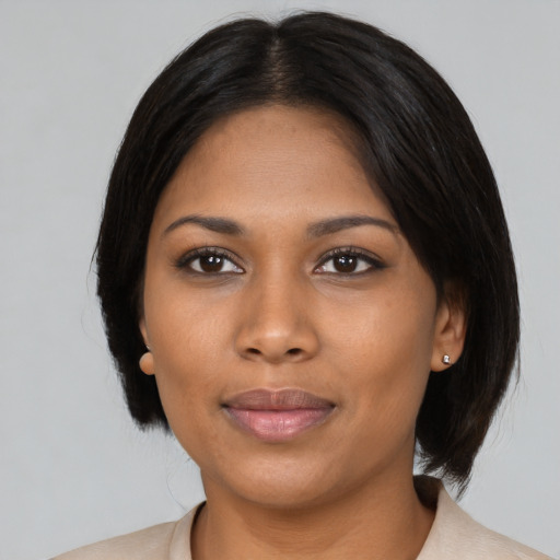 Joyful black young-adult female with medium  black hair and brown eyes