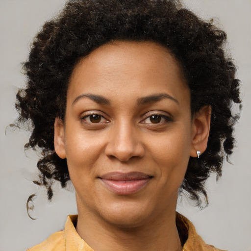 Joyful black young-adult female with medium  brown hair and brown eyes