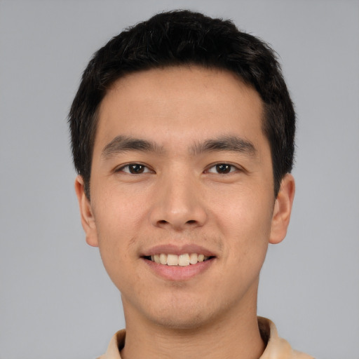 Joyful asian young-adult male with short  black hair and brown eyes