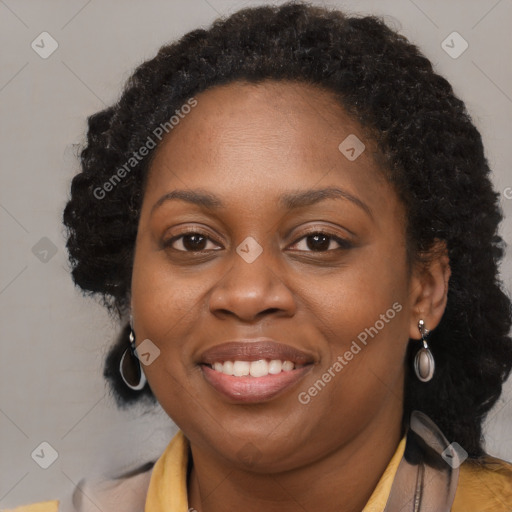 Joyful black adult female with long  brown hair and brown eyes