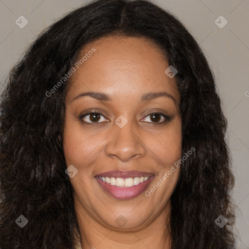 Joyful black young-adult female with long  brown hair and brown eyes