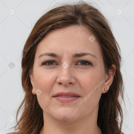 Joyful white adult female with long  brown hair and grey eyes