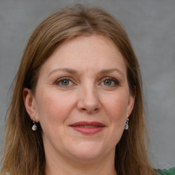 Joyful white adult female with long  brown hair and grey eyes