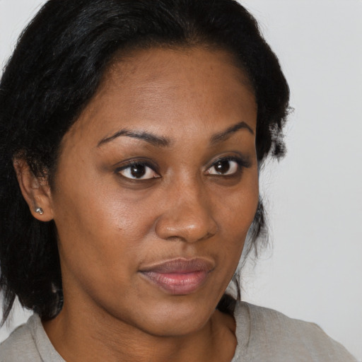 Joyful black young-adult female with medium  brown hair and brown eyes