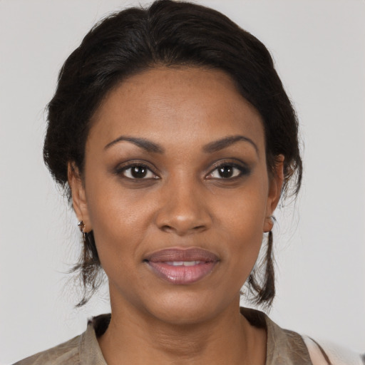 Joyful black young-adult female with medium  brown hair and brown eyes