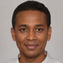 Joyful black young-adult male with short  black hair and brown eyes