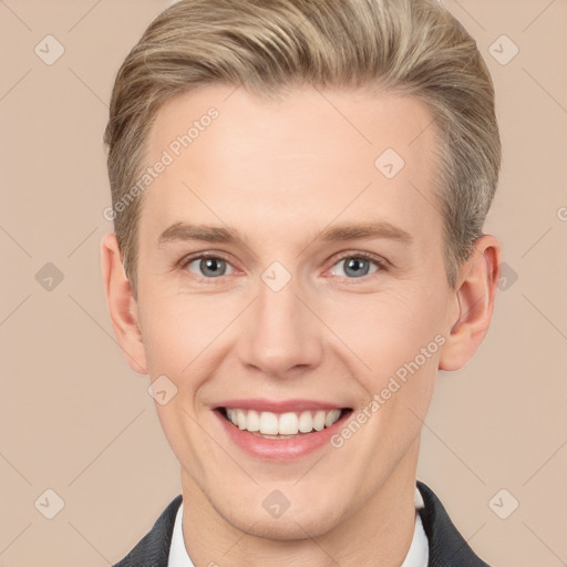 Joyful white young-adult male with short  brown hair and grey eyes