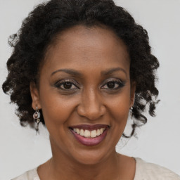 Joyful black adult female with short  brown hair and brown eyes