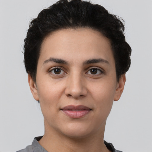 Joyful white young-adult female with short  black hair and brown eyes