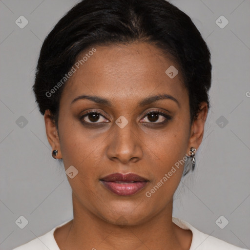 Joyful black young-adult female with short  black hair and brown eyes