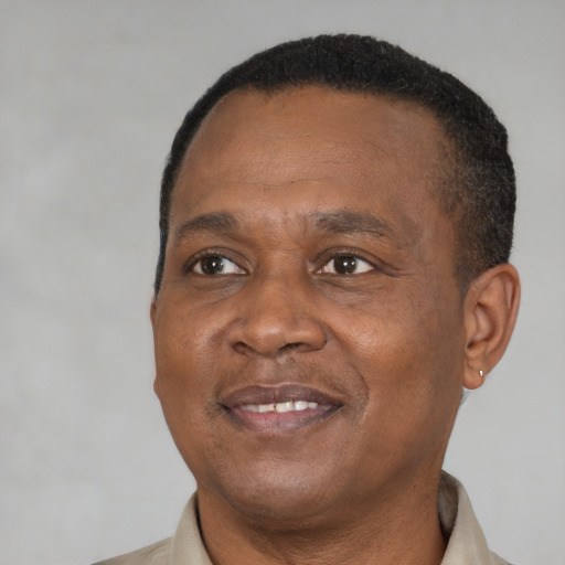 Joyful black adult male with short  brown hair and brown eyes