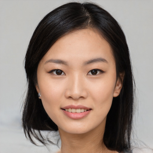 Joyful asian young-adult female with medium  black hair and brown eyes