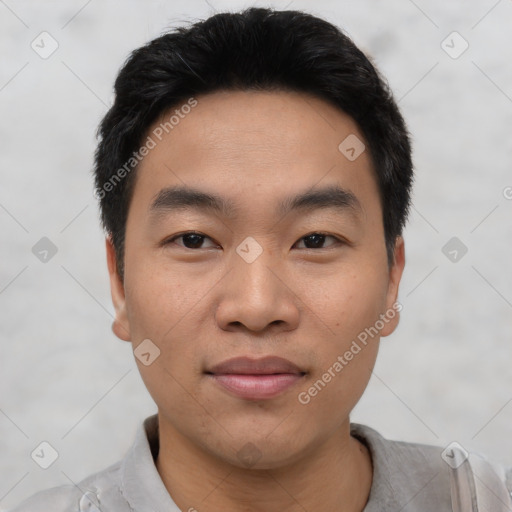 Joyful asian young-adult male with short  black hair and brown eyes