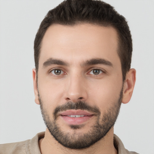 Joyful white young-adult male with short  brown hair and brown eyes