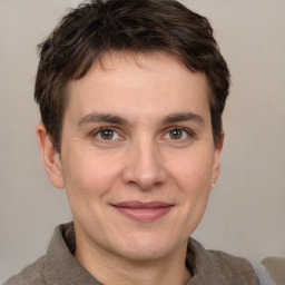 Joyful white adult male with short  brown hair and brown eyes