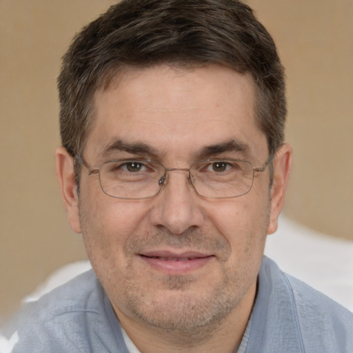 Joyful white adult male with short  brown hair and brown eyes