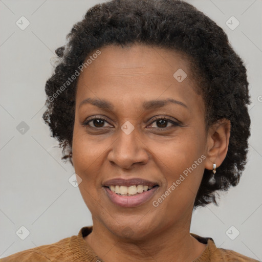 Joyful black adult female with short  brown hair and brown eyes