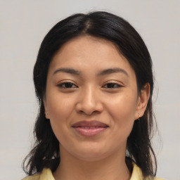 Joyful asian young-adult female with medium  brown hair and brown eyes