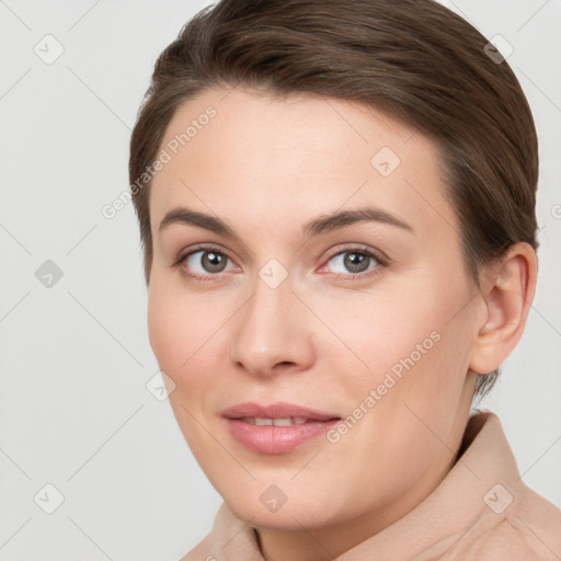 Joyful white young-adult female with short  brown hair and brown eyes