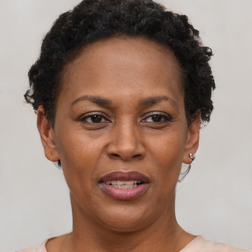 Joyful black young-adult female with short  brown hair and brown eyes