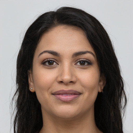 Joyful latino young-adult female with long  brown hair and brown eyes