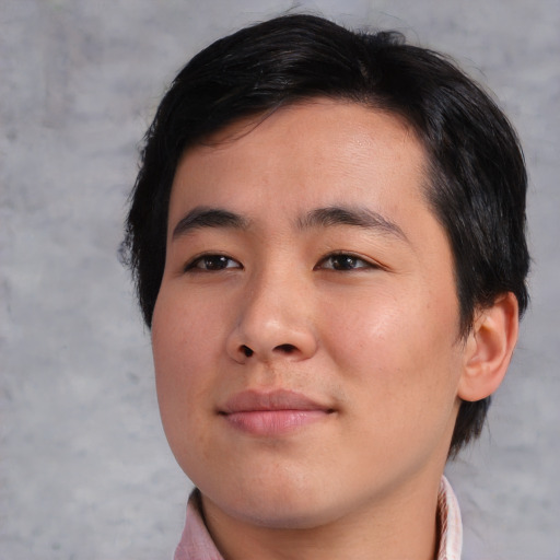 Joyful asian young-adult male with medium  brown hair and brown eyes