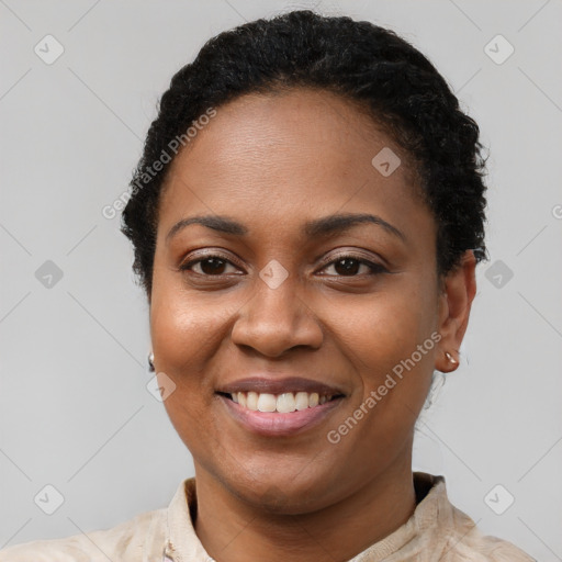 Joyful black young-adult female with short  brown hair and brown eyes