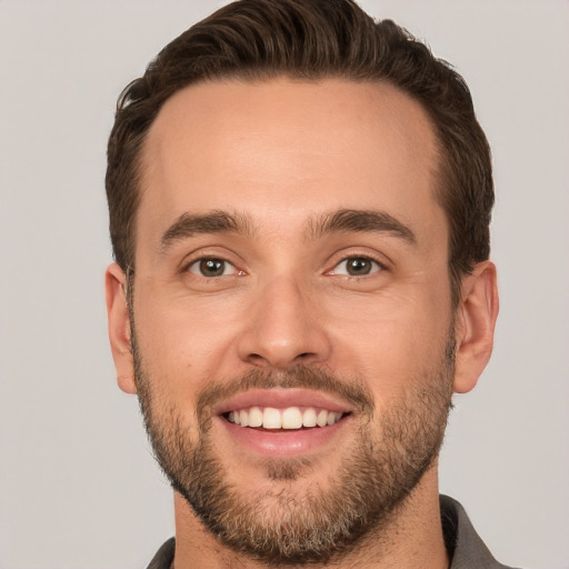 Joyful white young-adult male with short  brown hair and brown eyes