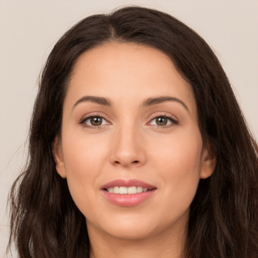 Joyful white young-adult female with long  brown hair and brown eyes