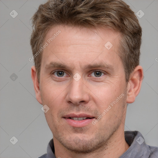 Joyful white adult male with short  brown hair and grey eyes