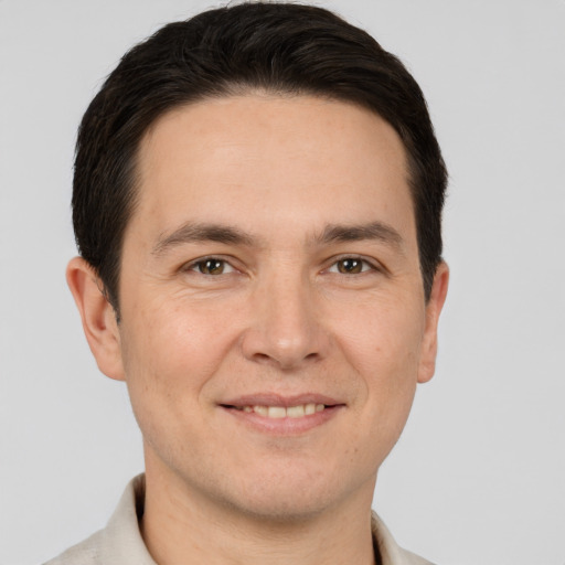 Joyful white adult male with short  brown hair and brown eyes