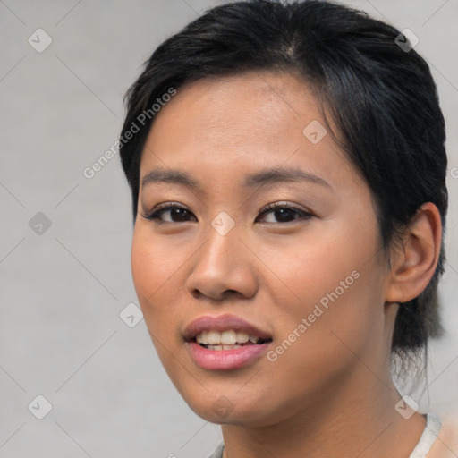 Joyful asian young-adult female with short  brown hair and brown eyes