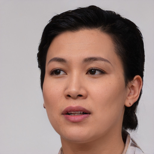 Joyful asian young-adult female with medium  black hair and brown eyes