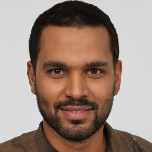 Joyful black young-adult male with short  black hair and brown eyes