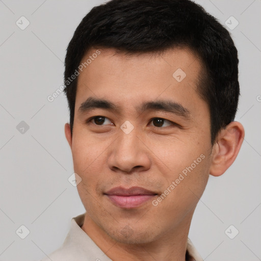 Joyful asian young-adult male with short  black hair and brown eyes