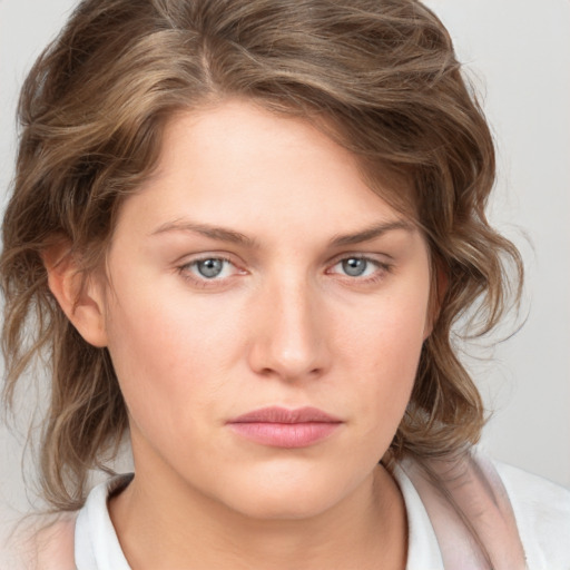 Joyful white young-adult female with medium  brown hair and blue eyes