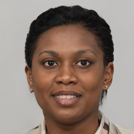 Joyful black young-adult female with short  black hair and brown eyes