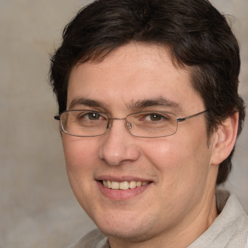 Joyful white adult male with short  brown hair and brown eyes