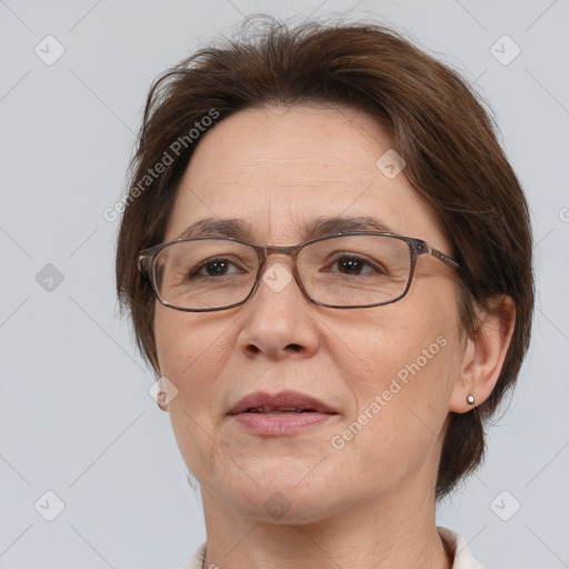 Joyful white adult female with medium  brown hair and brown eyes