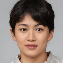 Joyful asian young-adult female with short  brown hair and brown eyes