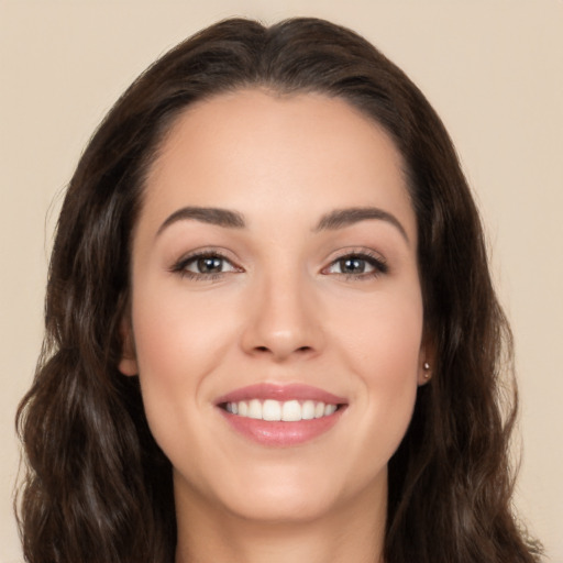 Joyful white young-adult female with long  brown hair and brown eyes