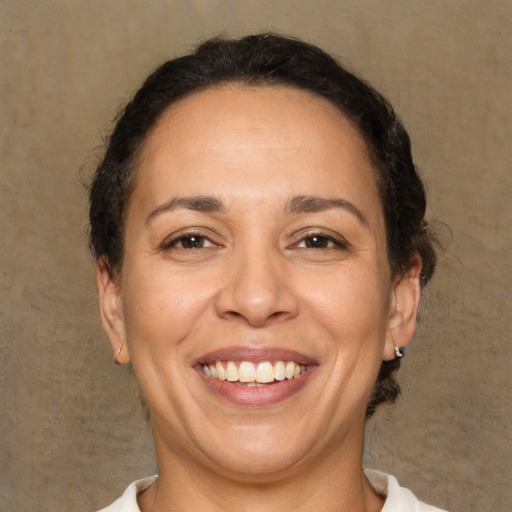 Joyful white adult female with short  brown hair and brown eyes